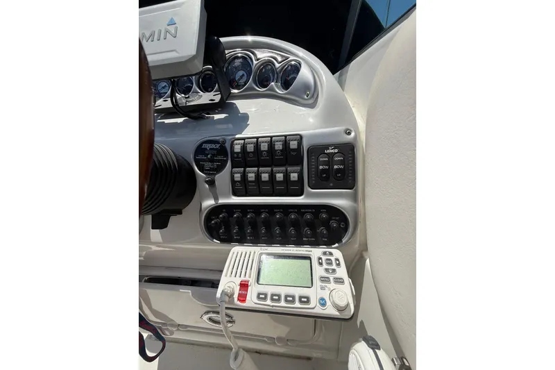 Slide: The Image of Control panel of a 2011 Crownline 236 SC boat with gauges and switches. - 24
