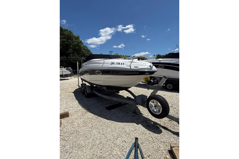 Slide: The Image of 2011 Crownline 236 SC boat on trailer under clear blue sky. - 3
