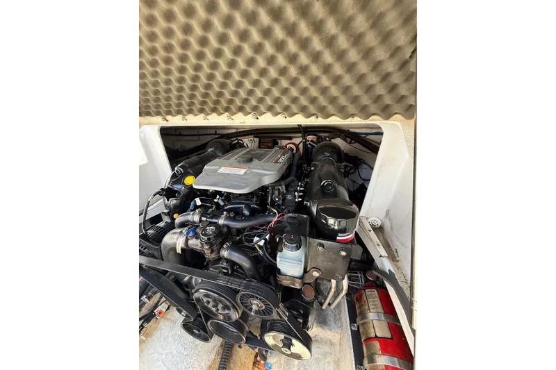 Slide: The Image of Engine compartment of a 2011 Crownline 236 SC boat with visible components. - 31