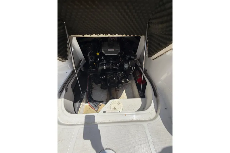 Slide: The Image of Engine compartment of a 2011 Crownline 236 SC boat, showing mechanical components. - 33