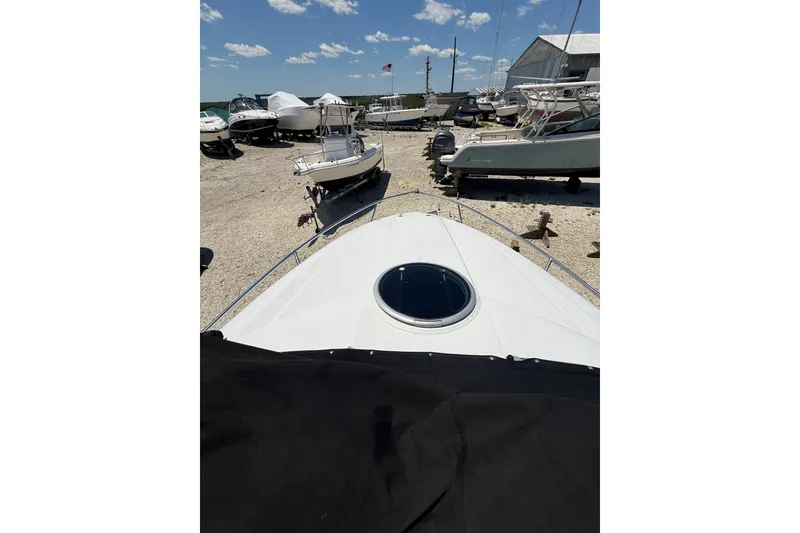 Slide: The Image of 2011 Crownline 236 SC boat in a marina with other vessels. - 35