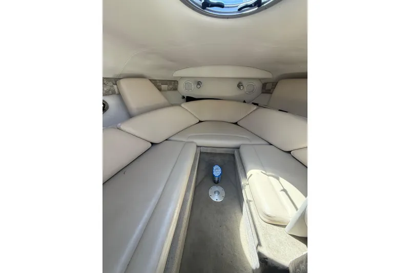 Slide: The Image of Interior cabin of 2011 Crownline 236 SC boat with beige seating and porthole. - 36