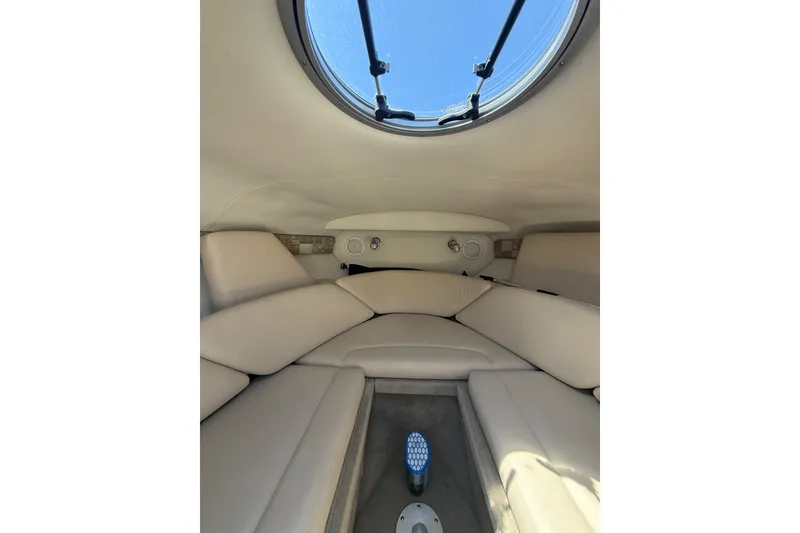Slide: The Image of Interior cabin of 2011 Crownline 236 SC boat with beige seating and porthole window. - 37