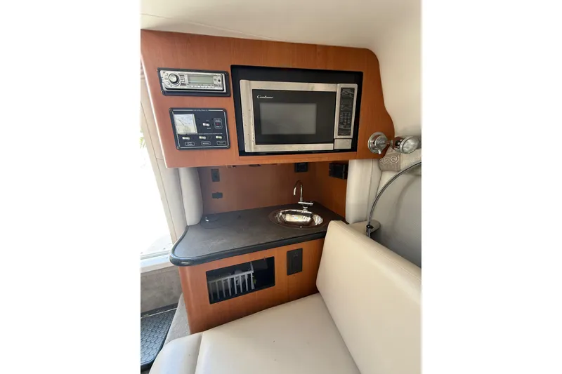 Slide: The Image of 2011 Crownline 236 SC cabin interior with microwave, sink, and control panel. - 38