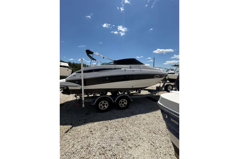 Slide: The Image of 2011 Crownline 236 SC boat on trailer under clear blue sky. - 4