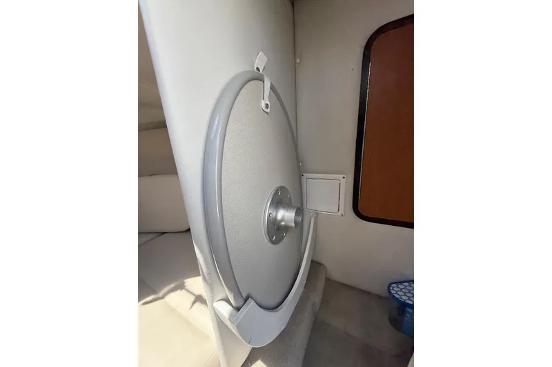 Slide: The Image of 2011 Crownline 236 SC cabin interior with circular hatch and seating area. - 41
