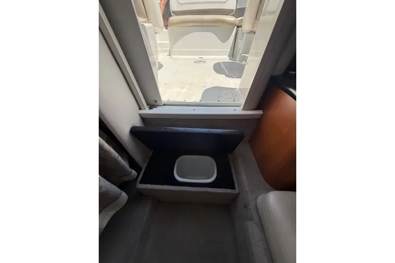 Slide: The Image of Interior view of 2011 Crownline 236 SC boat with storage compartment open. - 46