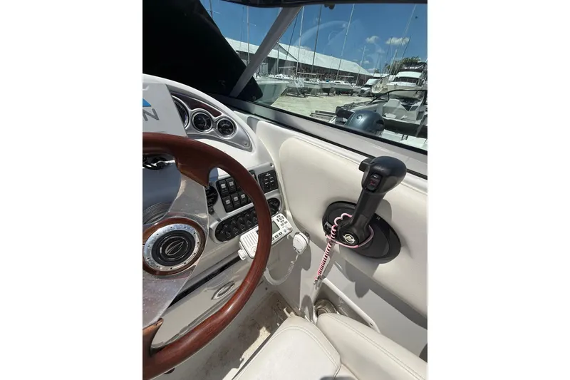 Slide: The Image of Interior view of 2011 Crownline 236 SC boat cockpit with steering wheel and controls. - 47