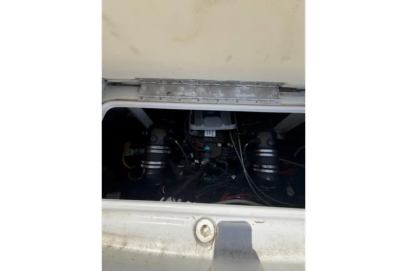 Slide: The Image of Engine compartment of a 2011 Crownline 236 SC boat, showing mechanical components. - 48