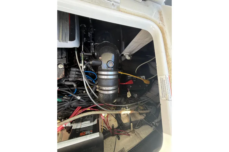 Slide: The Image of Engine compartment of a 2011 Crownline 236 SC boat, showing wiring and components. - 49