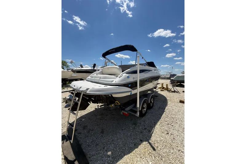 Slide: The Image of 2011 Crownline 236 SC boat on trailer under clear blue sky. - 5