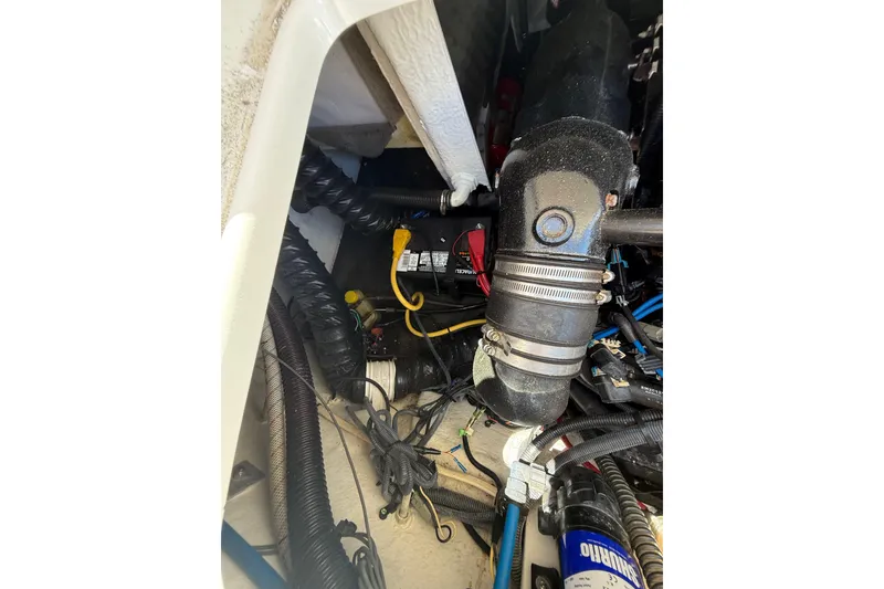 Slide: The Image of Engine compartment of a 2011 Crownline 236 SC boat, showing hoses and wiring. - 50