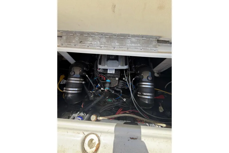 Slide: The Image of Engine compartment of a 2011 Crownline 236 SC boat, showing mechanical components and wiring. - 51