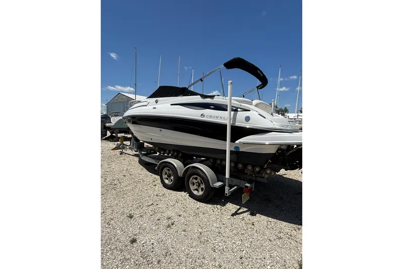 Slide: The Image of 2011 Crownline 236 SC boat on trailer under clear blue sky. - 9