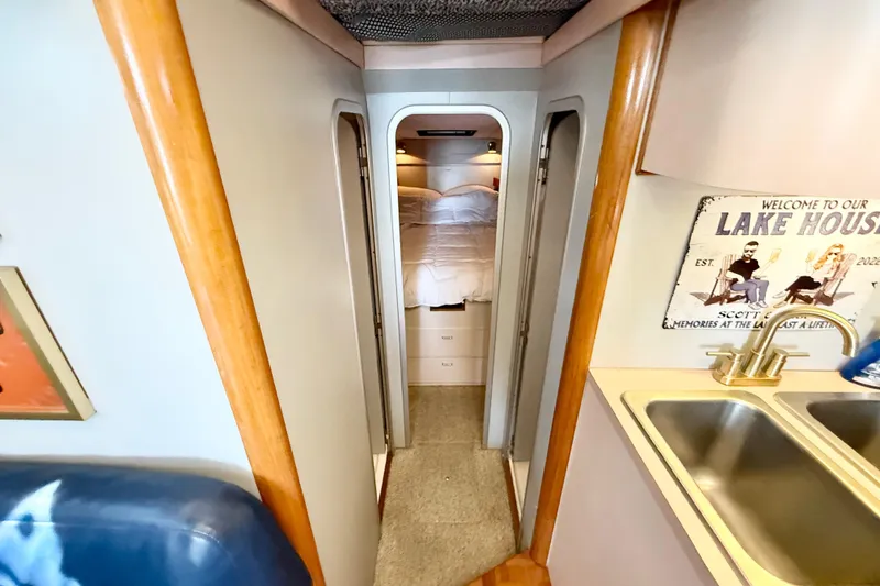 Slide: The Image of Interior view of 1990 Luhrs 3400 Motor Yacht, featuring cozy cabin and kitchenette. - 10