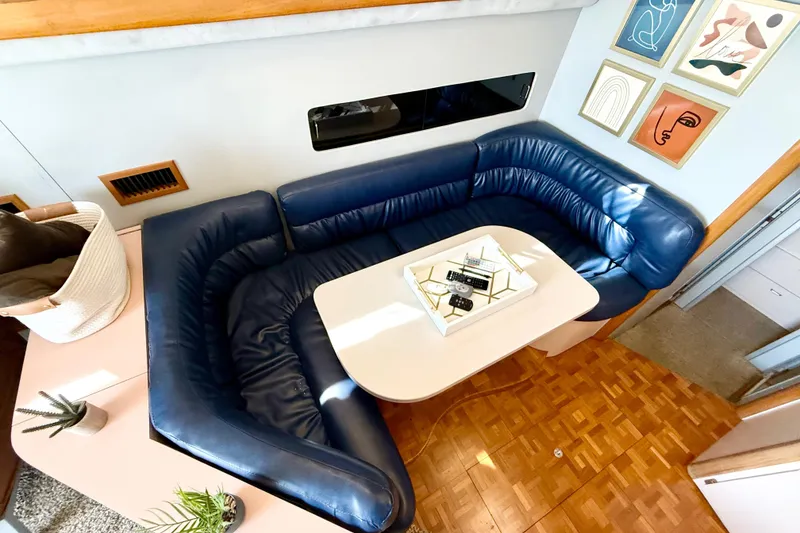 Slide: The Image of Luxurious 1990 Luhrs 3400 Motor Yacht interior with blue leather seating and modern decor. - 12