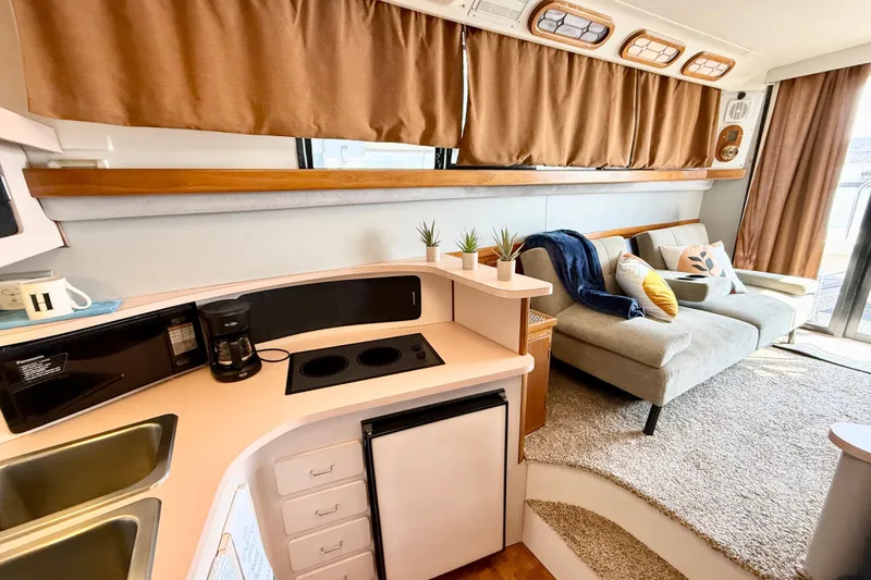 Slide: The Image of Interior of 1990 Luhrs 3400 Motor Yacht with cozy living area and kitchenette. - 14