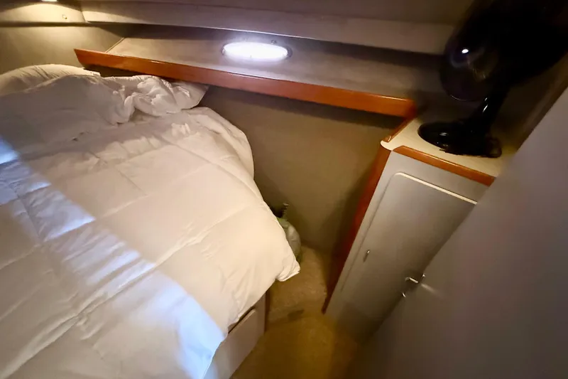 Slide: The Image of Cozy bedroom in 1990 Luhrs 3400 Motor Yacht with bed and cabinet. - 18
