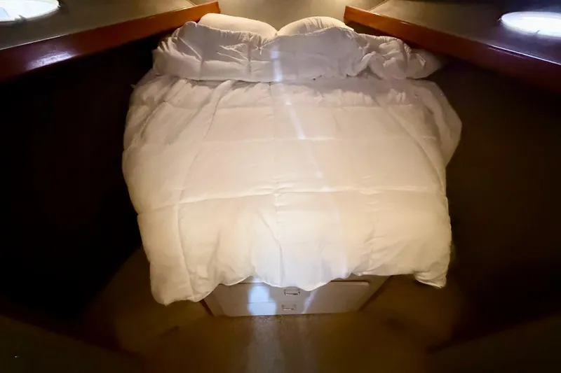 Slide: The Image of Cozy bedroom in 1990 Luhrs 3400 Motor Yacht with white bedding. - 19