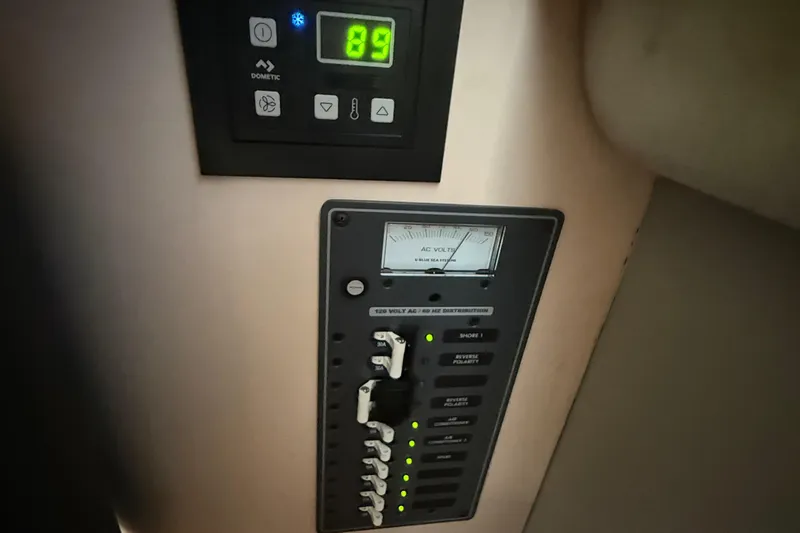 Slide: The Image of Control panel on a 1990 Luhrs 3400 Motor Yacht, featuring voltage and system indicators. - 22