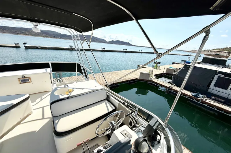 Slide: The Image of 1990 Luhrs 3400 Motor Yacht interior with scenic marina view. - 30