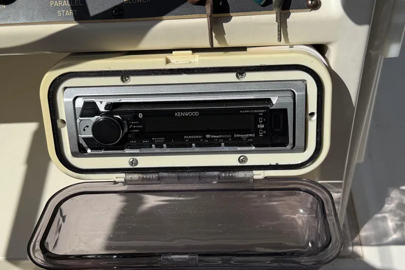Slide: The Image of Kenwood stereo system on 1990 Luhrs 3400 Motor Yacht dashboard. - 33