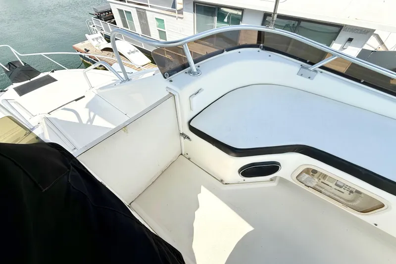 Slide: The Image of 1990 Luhrs 3400 Motor Yacht deck with railing and seating area. - 34