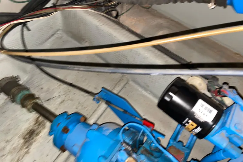 Slide: The Image of Engine compartment of a 1990 Luhrs 3400 Motor Yacht, featuring mechanical components and wiring. - 40