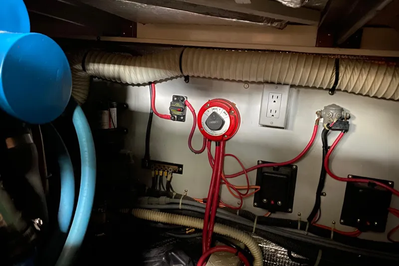 Slide: The Image of Engine room wiring of a 1990 Luhrs 3400 Motor Yacht, featuring cables and control panel. - 41