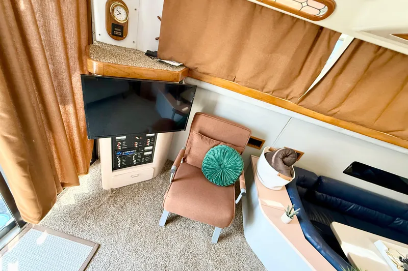 Slide: The Image of Interior of 1990 Luhrs 3400 Motor Yacht with TV, chair, and decor elements. - 8