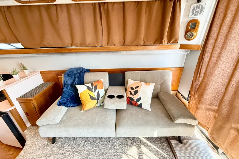 Slide: The Image of Cozy interior of 1990 Luhrs 3400 Motor Yacht with sofa and decorative pillows. - 9
