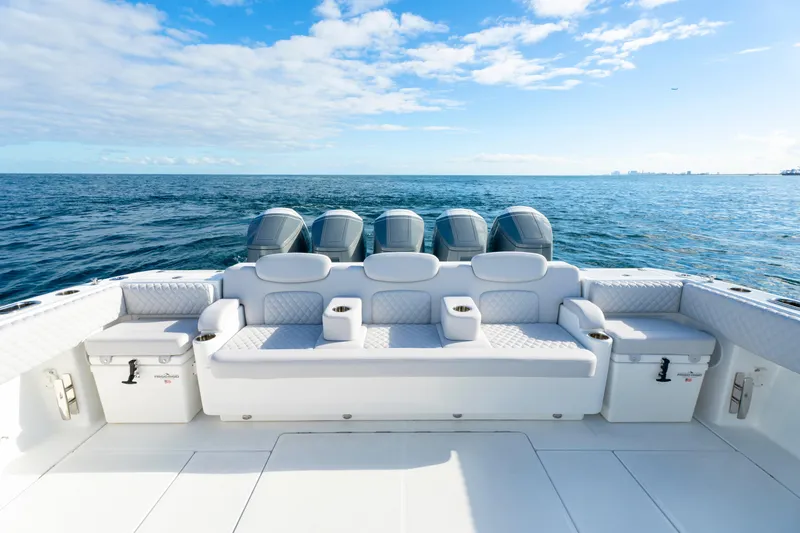 Slide: The Image of Luxurious 2027 HCB 56 Suenos boat with spacious seating, ocean view, and multiple engines. - 13