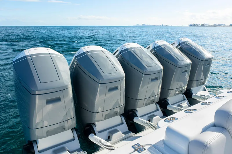 Slide: The Image of Five powerful outboard engines on a 2027 HCB 56 Suenos boat, cruising on open water. - 15