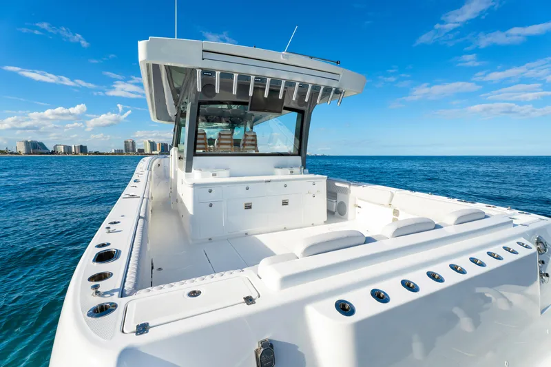 Slide: The Image of Luxury 2027 HCB 56 Suenos boat on open ocean, clear blue sky background. - 16