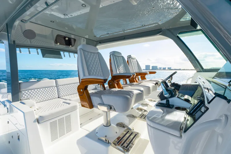 Slide: The Image of Luxurious interior of 2027 HCB 56 Suenos yacht with plush seating and modern controls. - 22