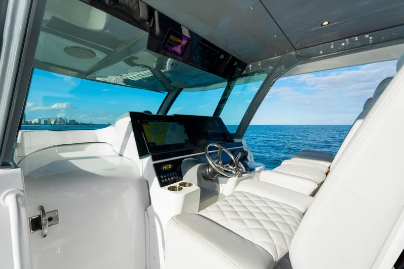 Slide: The Image of Luxurious helm of 2027 HCB 56 Suenos yacht with ocean view and modern controls. - 25