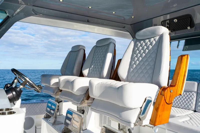 Slide: The Image of Luxurious seating on the 2027 HCB 56 Suenos boat, featuring elegant white upholstery. - 26