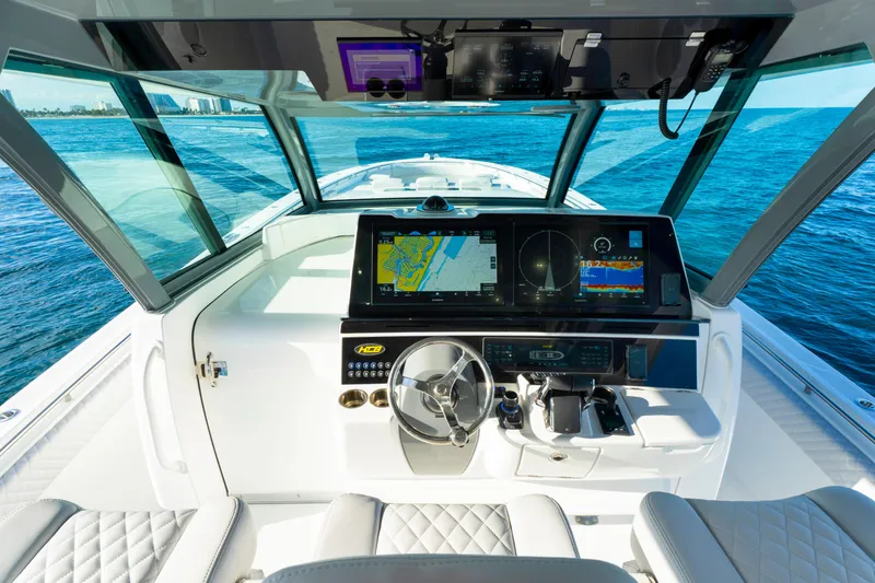 Slide: The Image of Helm of 2027 HCB 56 Suenos boat with advanced navigation systems on open water. - 28