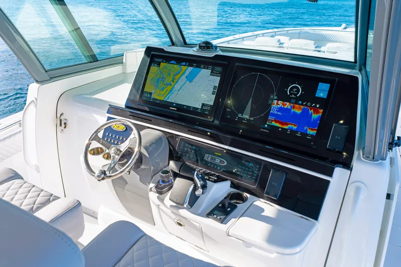 Slide: The Image of Helm of 2027 HCB 56 Suenos boat with advanced navigation displays and controls. - 29