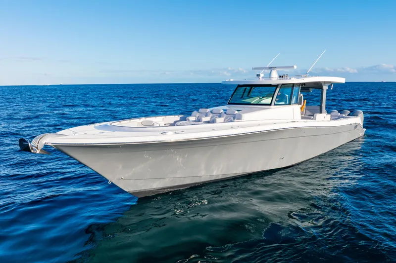 Slide: The Image of Luxury 2027 HCB 56 Suenos boat cruising on open ocean under clear blue sky. - 3