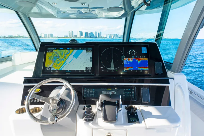 Slide: The Image of Helm of 2027 HCB 56 Suenos boat with advanced navigation displays and controls. - 30