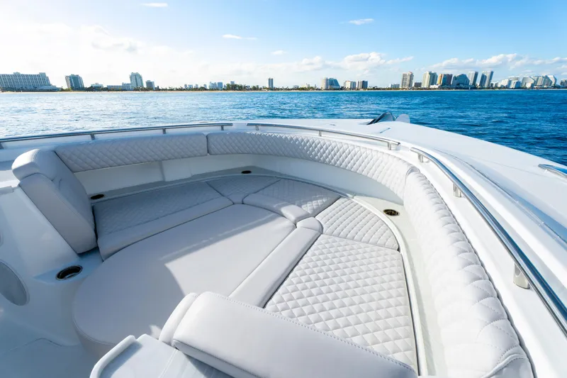 Slide: The Image of Luxurious seating on the 2027 HCB 56 Suenos yacht, with city skyline in background. - 33