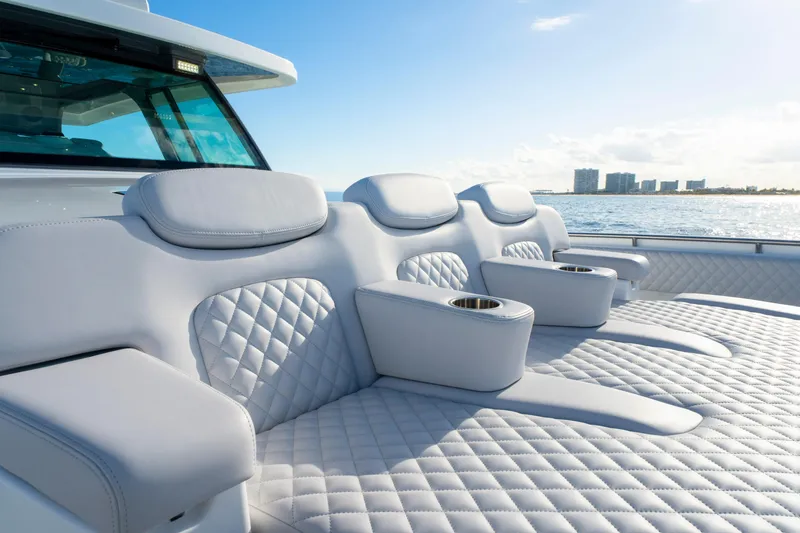 Slide: The Image of Luxurious seating on the 2027 HCB 56 Suenos yacht, featuring quilted upholstery and cup holders. - 36