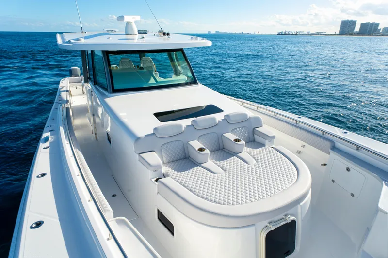 Slide: The Image of 2027 HCB 56 Suenos luxury yacht on open water, featuring sleek design and spacious deck. - 38