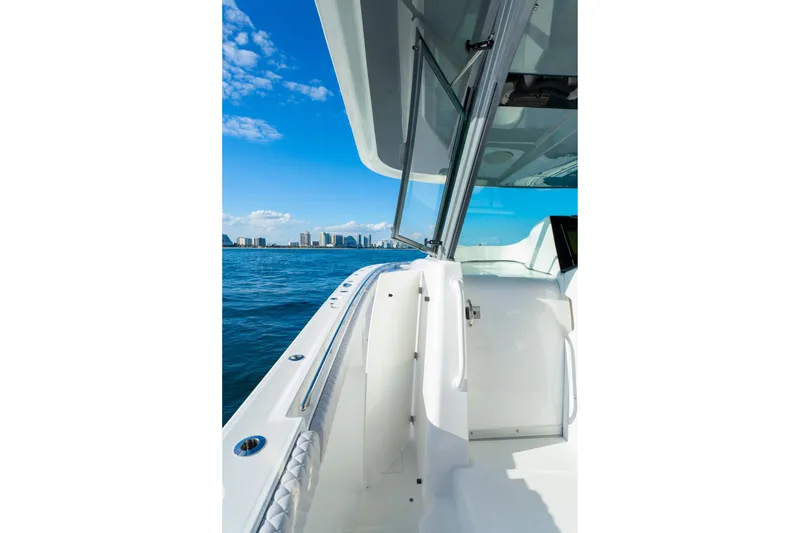 Slide: The Image of 2027 HCB 56 Suenos boat deck with ocean view and city skyline. - 41