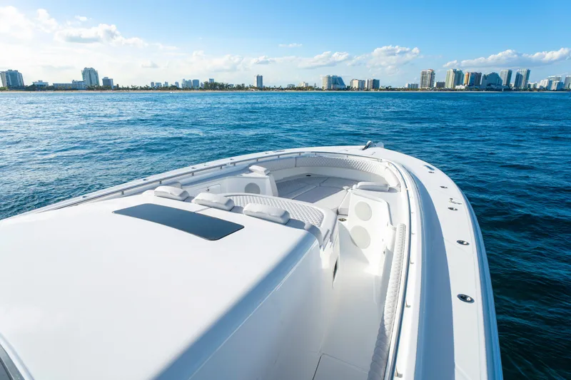 Slide: The Image of 2027 HCB 56 Suenos luxury boat cruising near city skyline on a sunny day. - 43