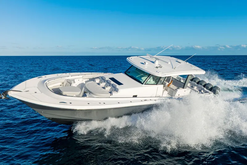 Slide: The Image of 2027 HCB 56 Suenos luxury boat cruising on open ocean under clear blue sky. - 45
