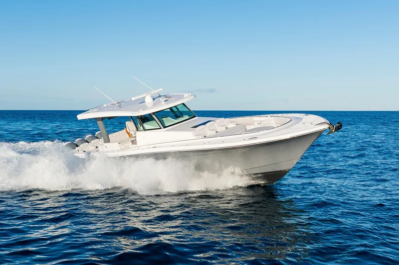 Slide: The Image of HCB 56 Suenos 2027 cruising on open ocean under clear blue sky. - 48
