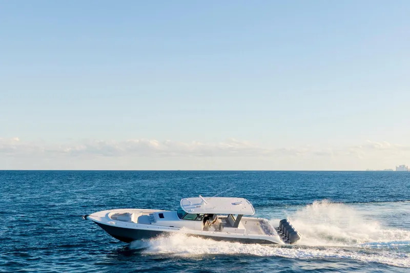 Slide: The Image of 2027 HCB 56 Suenos boat cruising on open ocean under clear blue sky. - 49