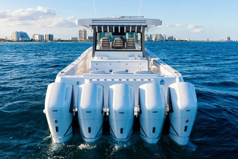 Slide: The Image of 2027 HCB 56 Suenos boat with five powerful engines cruising on open water. - 5